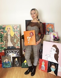 a woman standing in front of a room full of paintings