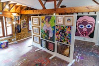 a room with a lot of paintings on the wall