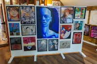 a display of paintings in a room