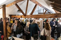 a group of people standing around in a barn