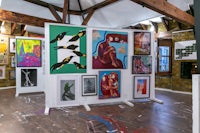 a room with a lot of paintings on the wall