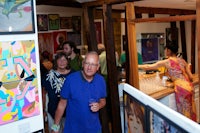 a group of people standing in an art gallery